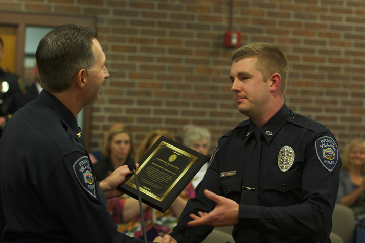 Officer Josh Fahlgren accepting his award from Police Chief Wes Jordan on Monday.
