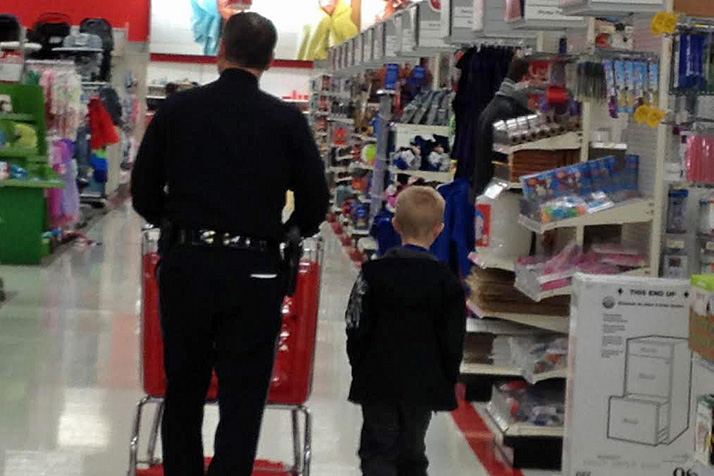 Prairie Village police help local youth find gifts for themselves and their families as part of the "Shop With a Cop" program.
