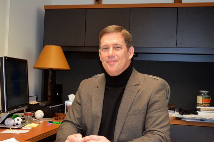 Dr. Jim Hinson at his desk in the Shawnee Mission administration building.