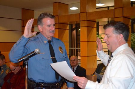 Westwood City Clerk Fred Sherman delivered the oath of office to new police chief Greg O'Halloran Thursday evening.