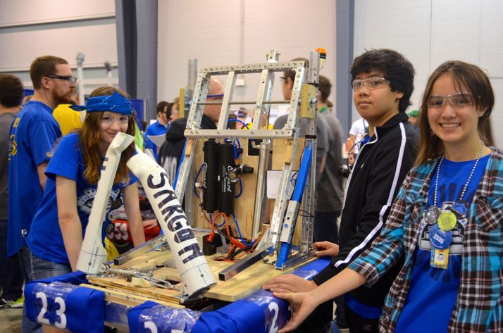 Some of the SM East team members taking their robot to the pits after a round.