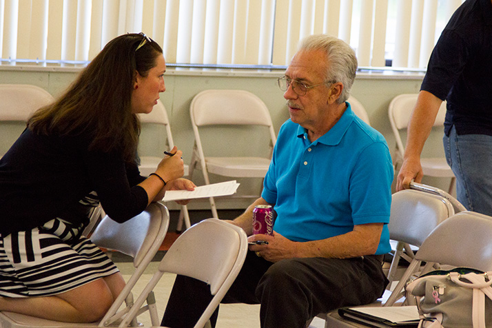 Roeland Park Councilor Megan England talks with Tom Madigan during the budget forum this week.