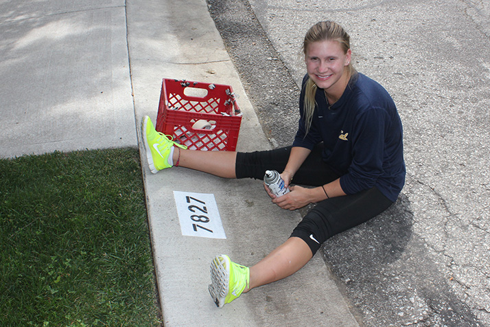 Fairway native Ellie Smart is painting numbers on northeast Johnson County curbs to raise money for her diving training.