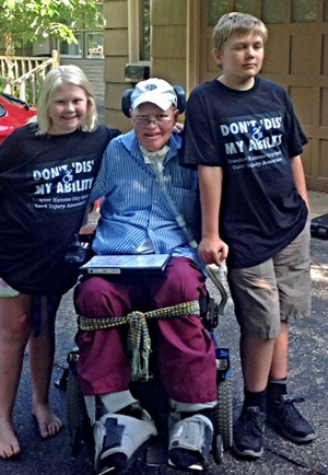 Finn Bullers (center) with children Alora (left) and Christian, before the family headed to the Merriam city council meeting Monday.
