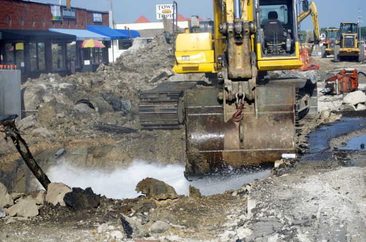 A water main break on Johnson Drive shot water high up into the air Wednesday evening before crews used a backhoe to force the spray toward a storm drain.