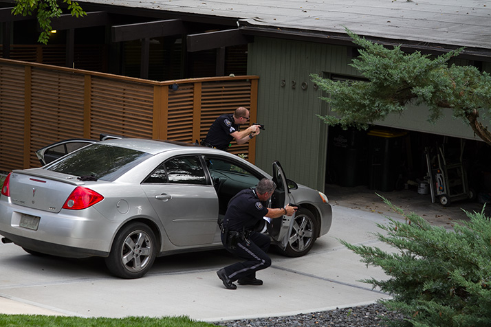 Prairie Village police investigators pulled their weapons as they swept a previously unchecked garage during their investigation after a September burglary that led to the arrest of three men.