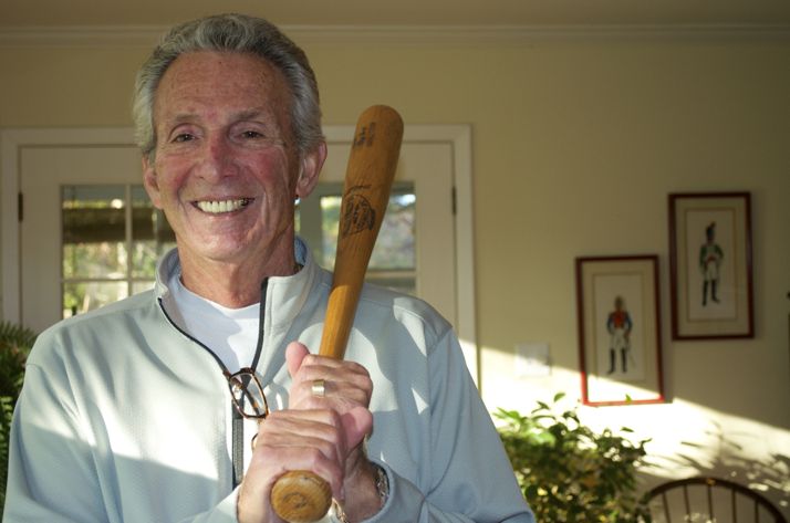 Alex George in his Prairie Village home with one of the autographed bats provided to him by Louisville Slugger in his playing days.