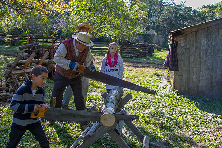 Young attendees got to try their hand at using a traditional longsaw.