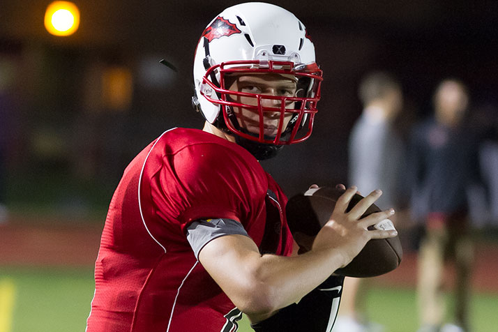SM North quarterback Will Schneider lost his helmet but kept the ball on a second quarter run that put the Indians up 13-3.