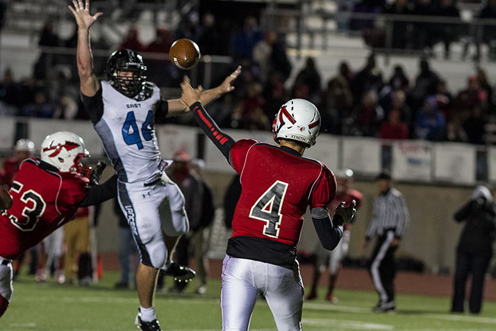 Kyle Ball jumped to try to block a pass from SM North's Will Schneider.