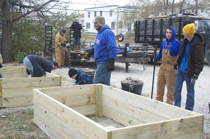 The scouts worked in the Saturday morning cold to build the raised beds.