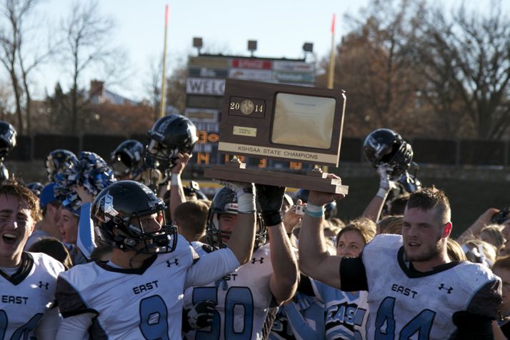 SM East players hoisted the 6A state football trophy after defeated Hutchinson 33-14 in the championship game.