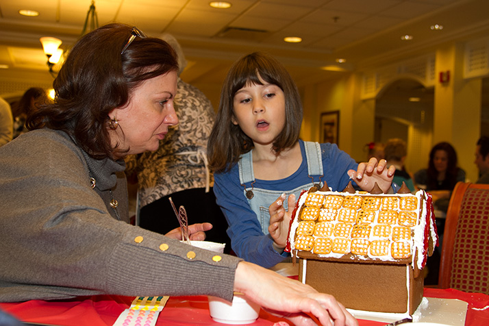 Carrie Fraker helped granddaughter Keegan Barton adorn her house with a roof of pretzels.