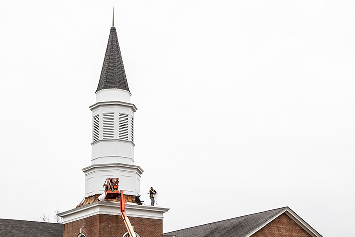 Crews worked to detach the steeple structure Tuesday.
