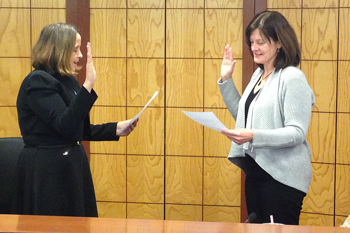 Laura Wassmer took the oath of office from City Clerk Joyce Hagen Mundy on Monday.