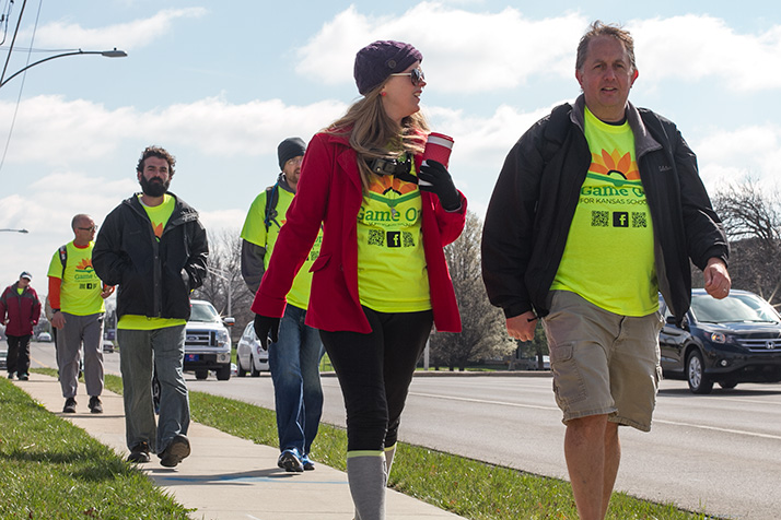 Walk founder Heather Ousley, in red jacket, and Ben Clayton heading west toward to Topeka from Johnson County in 2015.