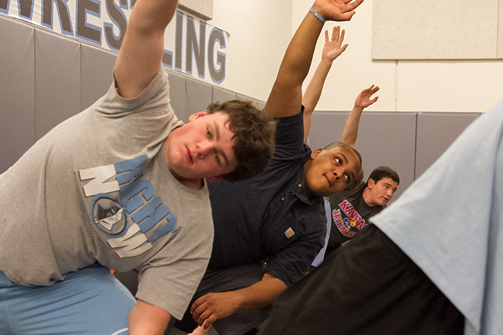 Calen Gilmore, center, who can squat 540 pounds, said yoga has helped him with his weightlifting.