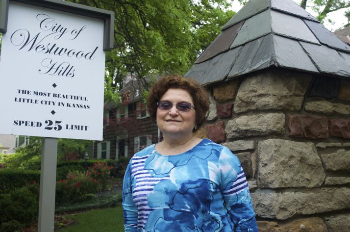 Westwood Hills Mayor Paula Schwach at one of the stone entry markers to the city.