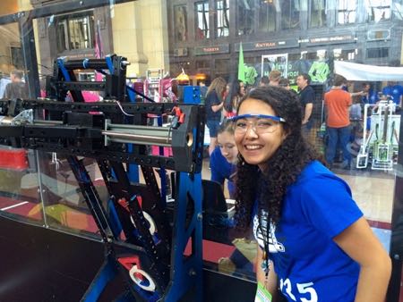 Cassy Roque (foreground) and Gabi Case (back) work on the SM East robot at the Kansas City Maker Faire.
