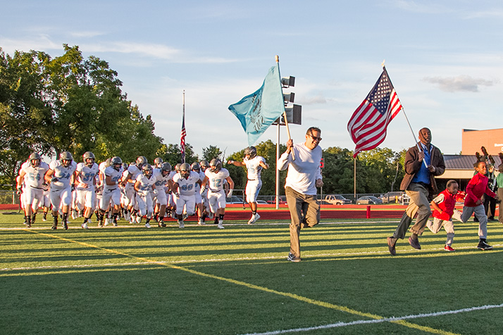 Principal John McKinney, an Army veteran, led the team onto the field for the Sept. 11 game.
