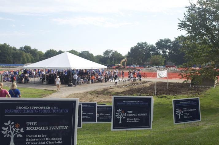 The last few remnants of the old school served as the backdrop for Friday's groundbreaking ceremony.