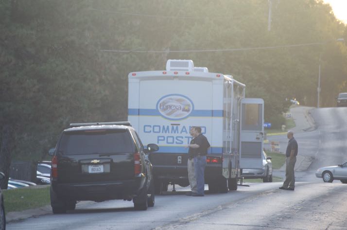 Officers at the command post set up to manage the standoff in Mission early Monday morning.