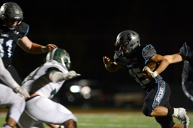 Senior Mike Bamford rushes for a eight yard gain leading to a first down for the Lancers. Photo by Joseph Cline