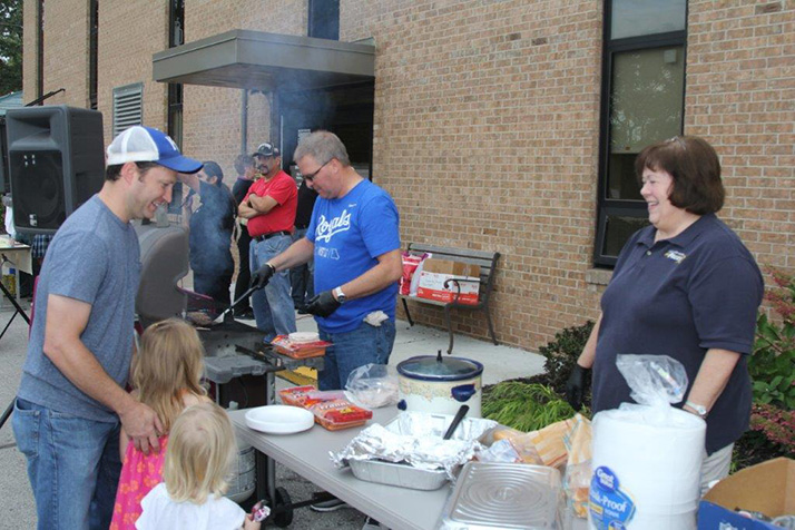 Police Chief John Morris mans the grill at Roeland Park's Night Out event.