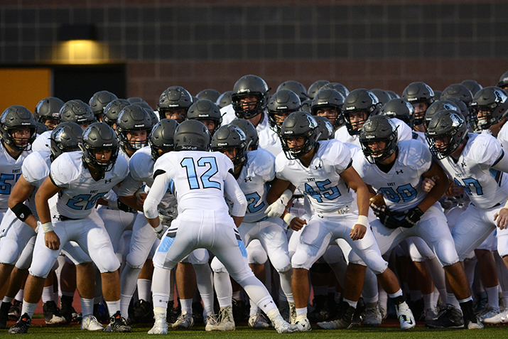 Senior Charlie Jensen leads the team huddle before taking the field. Photo by Joseph Cline