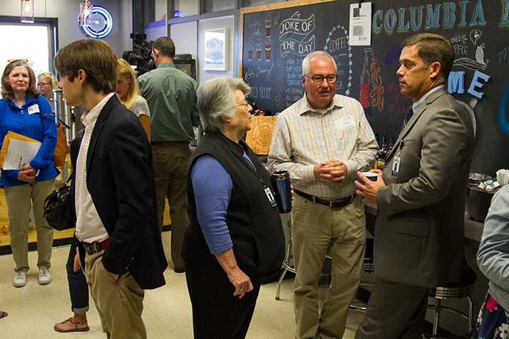 Shawnee Mission Superintendent Jim Hinson (right) and SM East Board of Education rep Donna Bysfield (center) chatted with The East Fund board member Brent Fuson at the reopening celebration Thursday.