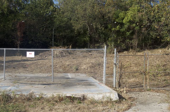 The slab that was part of the pool deck is visible on one side, but the pool is covered over.