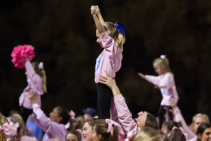 SM East's cheerleaders got help pumping up the crowd on the "Pink Out" night from youngsters who had participated in the Lancer Cheer clinic...