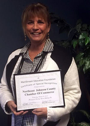 Northeast Johnson County Chamber President Deb Settle with the certificate of recognition from the MainStream Coalition.