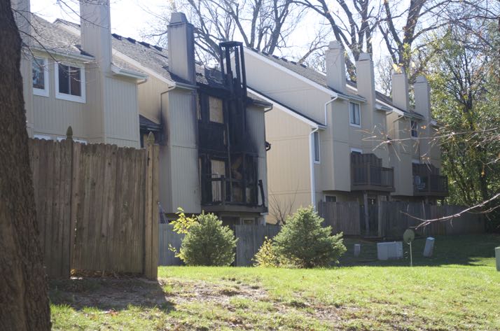 The apartment shows fire damage on the side where the deck is located.