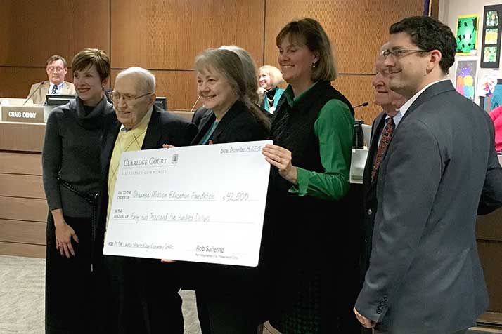 Representatives of Claridge Court presented the check for $42,500 at the Board of Education meeting Monday.