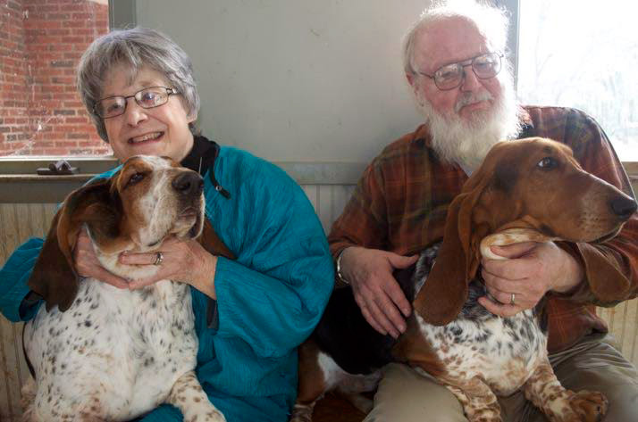 Missy and Doug Taylor at home with two of the four Basset Hounds they now own.