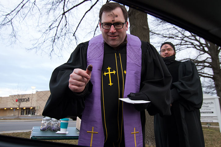 Colonial Church's Aaron Roberts braved the cold to deliver "Drive By Ash Wednesday" blessings.
