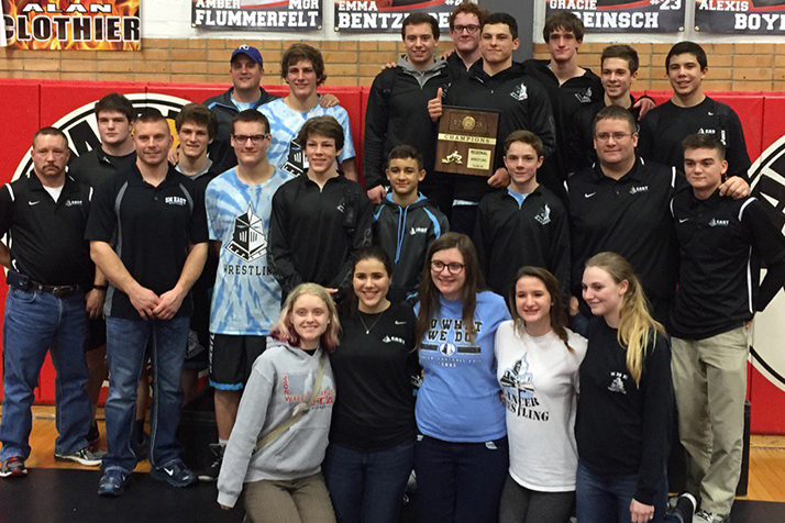 SM East wrestlers celebrating the Regionals win. Photo via Twitter.