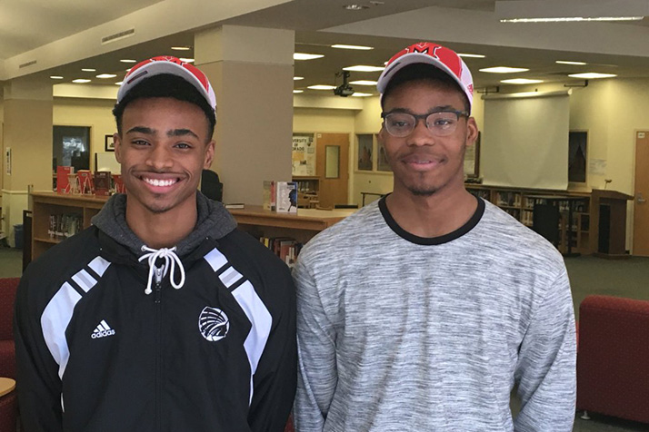Michael (left) and Marcus Weathers donning their new Redhawks caps after announcing their commitment to the University of Miami of Ohio. Photo via SMN Athletics on Twitter.