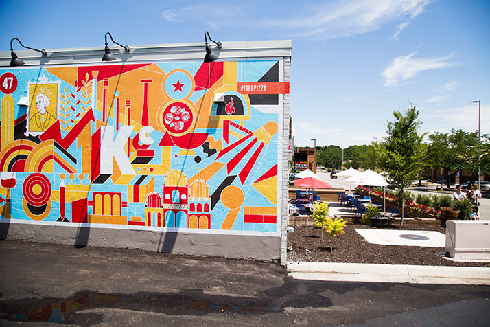 A bright mural adorns the east wall of the building next to the outdoor dining patio.