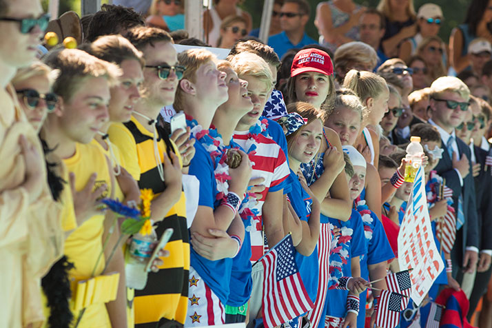 Swimmers from Carriage Club and Mission Hills lined the pool during the singing of the national anthem on Friday.