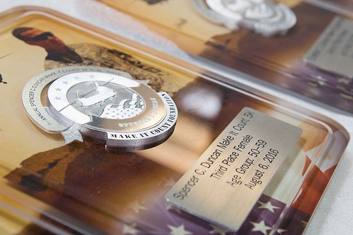 The awards feature an image of Duncan wrapped in acrylic with a medallion embedded on top.