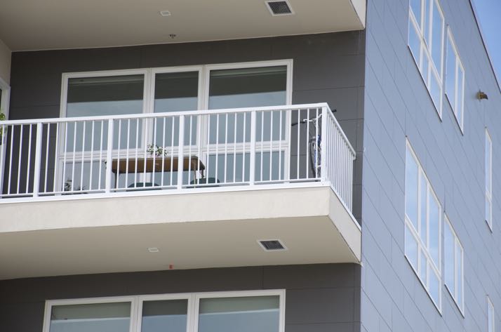 Evidence of occupancy was patio furniture and a bike on one of the Woodside apartment balconies.
