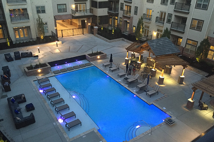The apartments overlook a courtyard with a luxury pool and gas grills that residents can use for entertaining. Photo courtesy Mission 106.