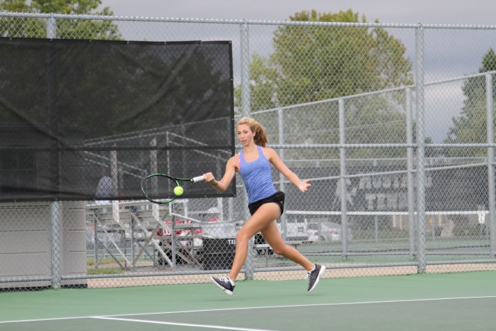 Junior Sarah Wilcox returns a ball during a match against Chloe Kuckelman. Wilcox fell 6-8, but will likely see Kuckelman again this weekend at regionals.