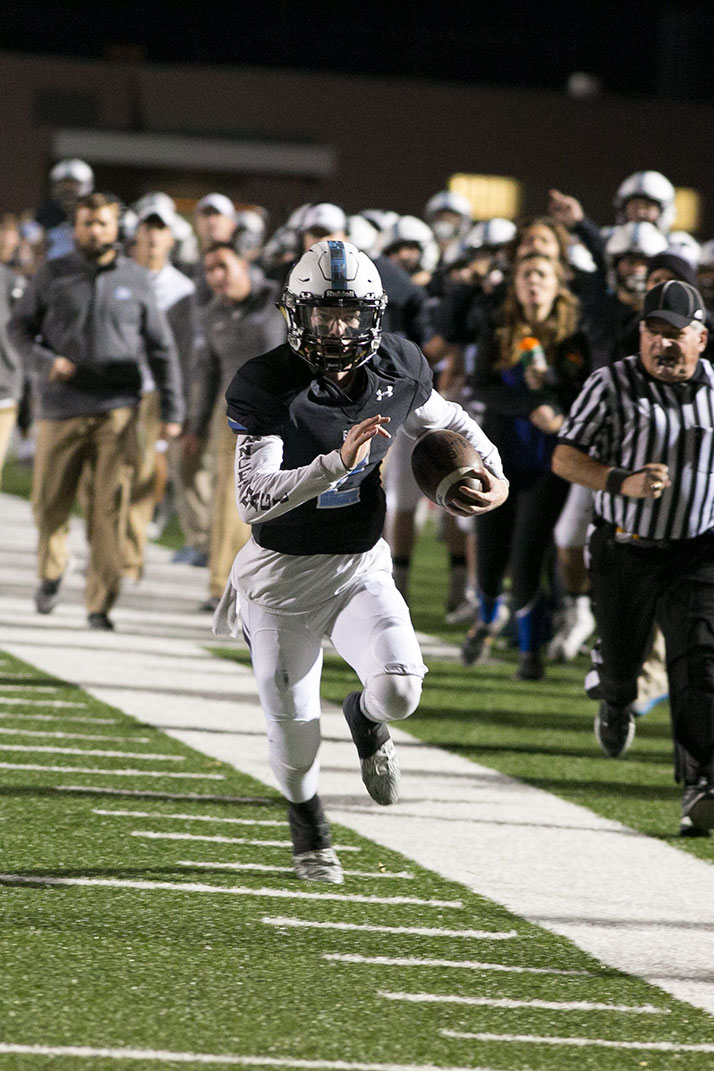 Luke Kaiser scrambled along the sideline late in the fourth quarter to set up the Lancers' final touchdown.