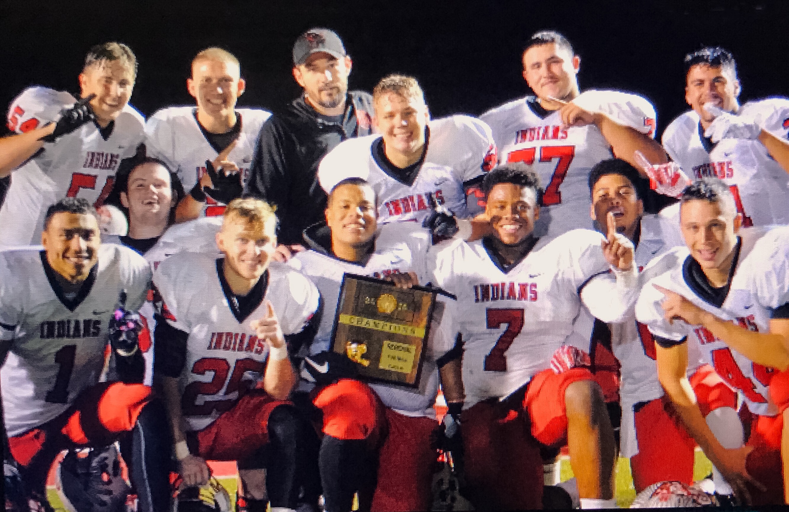 Shawnee Mission North poses with its regional championship trophy.