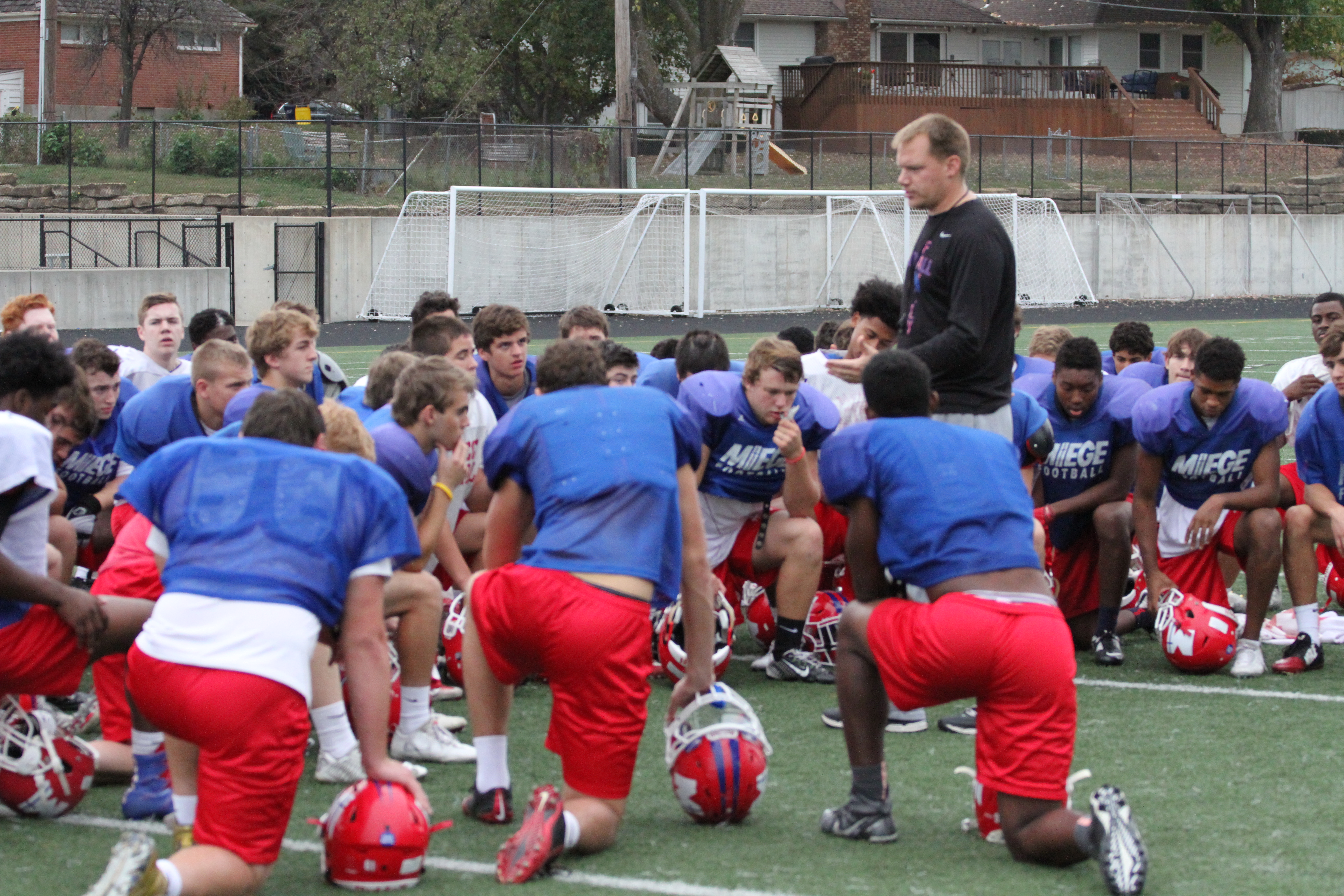 Bishop Miege coach Joh Holmes talks with his team after a short practice on Monday afternoon.