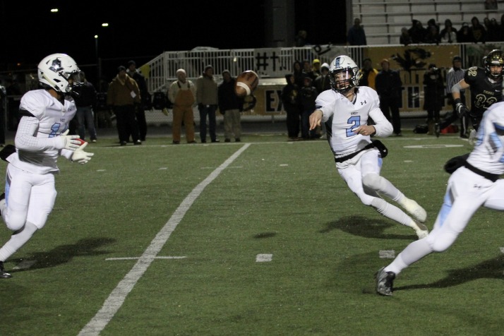Senior quarterback Luke Kaiser pitches a ball to senior running back Nigil Houston, who scored twice on the night. Houston scored the game-tying touchdown with a minute left as the Lancers were able to convert a two-point conversion.
