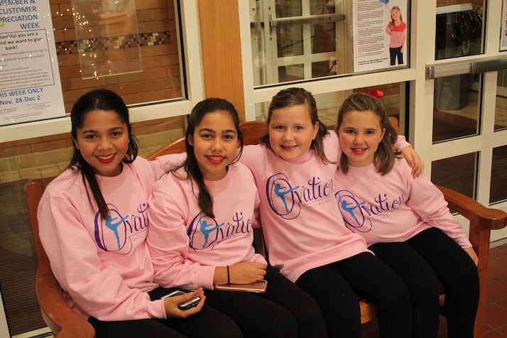 Ovation Dance Academy performers (from left) Katie Overstreet, 13; Kate Early, 13; Chloe Harmon, 8, and Eva Lowry, 8, share fun before taking the stage.